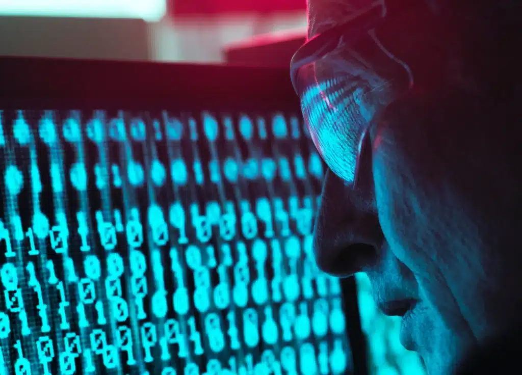 man looking at numbers on screen