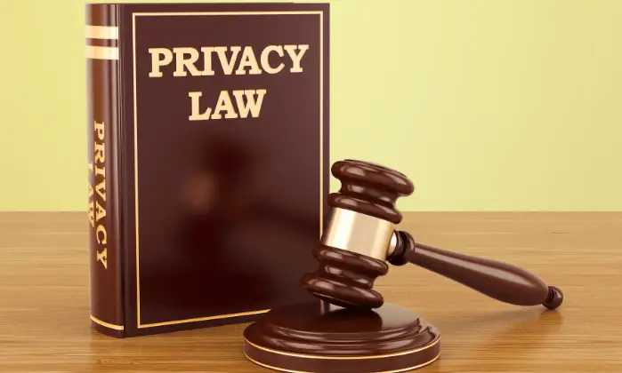 privacy law written on leather book with gavel on desk