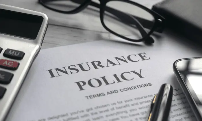 insurance policy document with glasses
