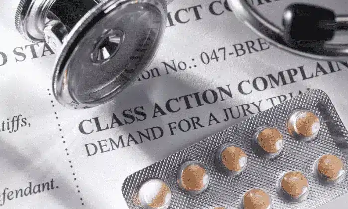 class action complaint with birth control pills and stethoscope