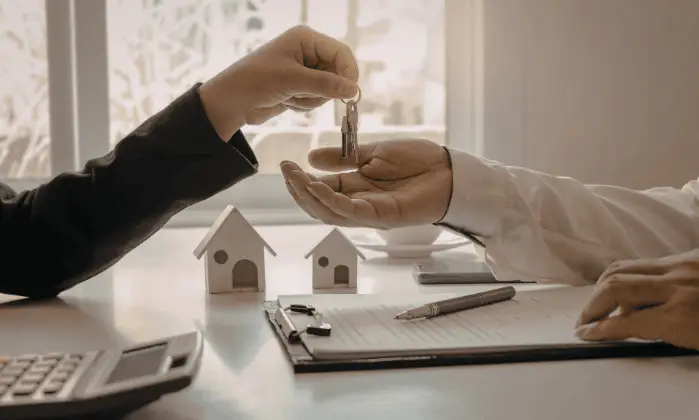 man giving customer keys to new house