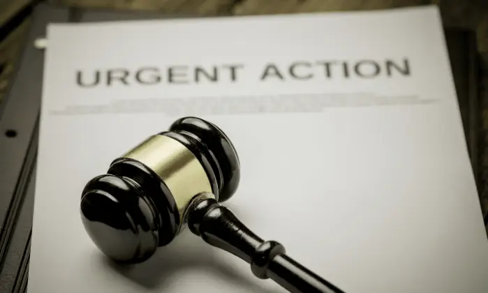 A gavel and a document labeled "URGENT ACTION.