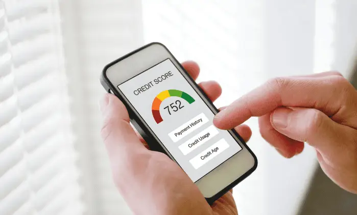 man looking at credit score on cell phone