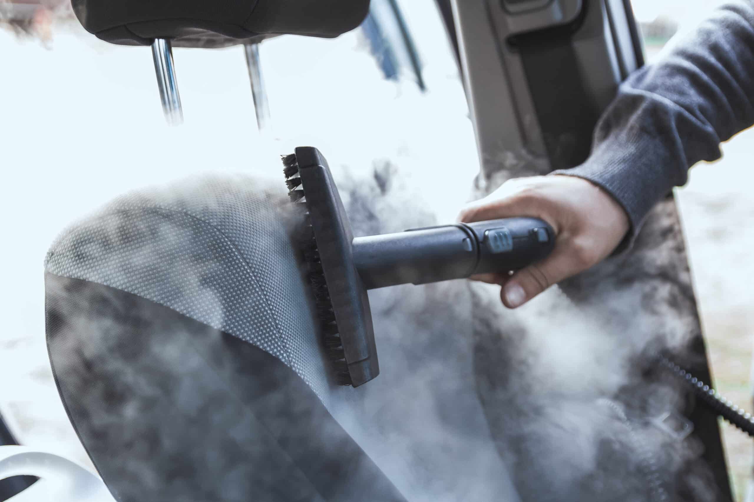 cleaning and disinfecting by steam of the car interior and a car seats with a steam cleaner