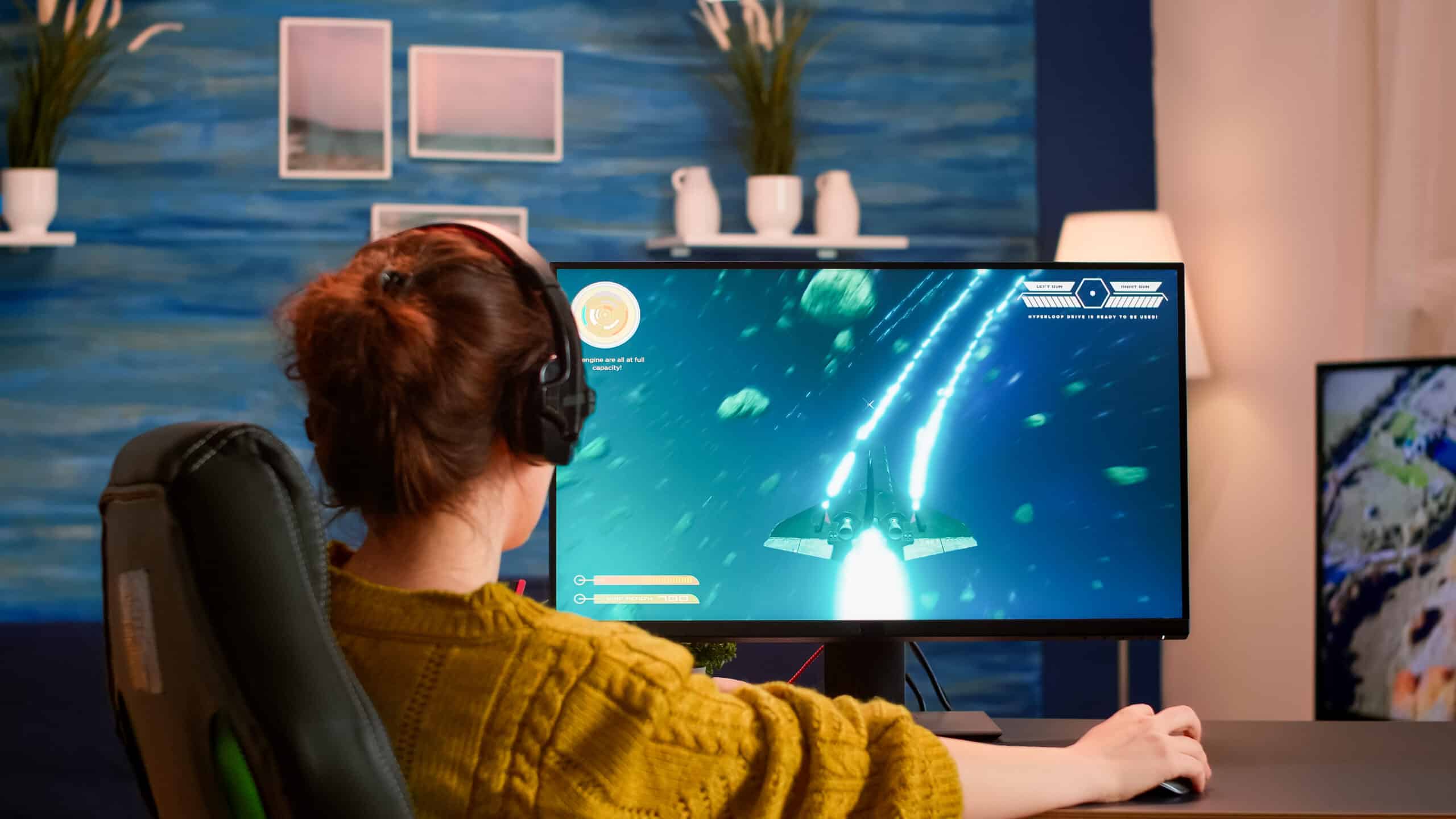 Pro gamer putting on headset testing new space shooter video game playing from home at professional computer. Virtual shooter game in cyberspace, esports player performing on pc gaming tournament