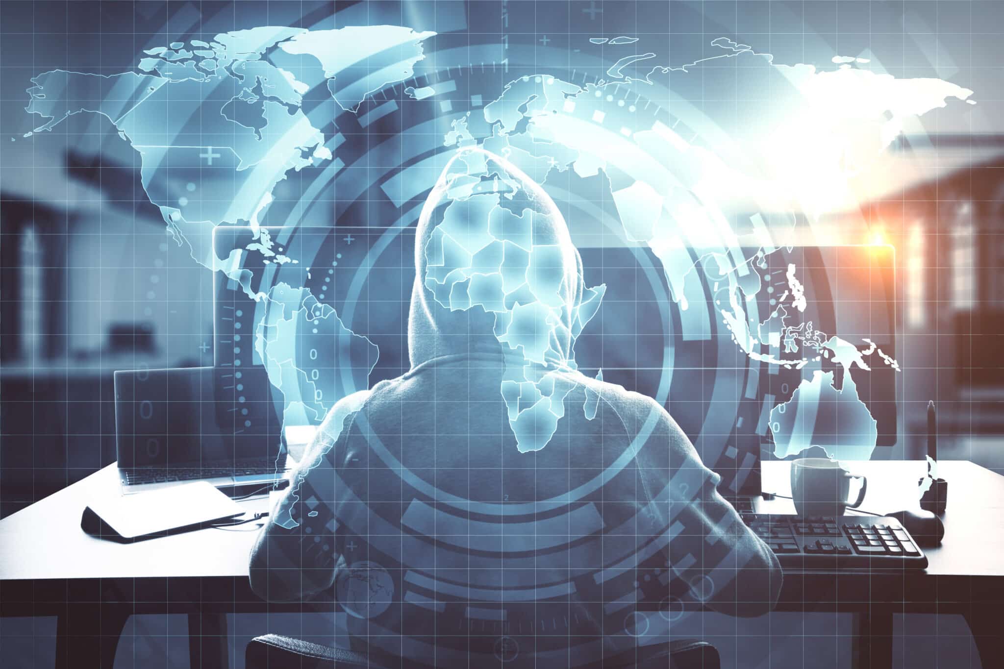 hooded-figure-works-at-computer-with-world-overlay-2026-03-26-05-05-04-utc