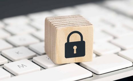 Computer Security protection concept. Cyber attack protection. Closed padlock icon on wooden block on computer keyboard