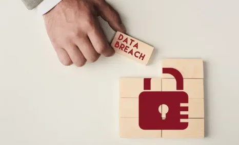 data breach written on wooden blocks with lock in red