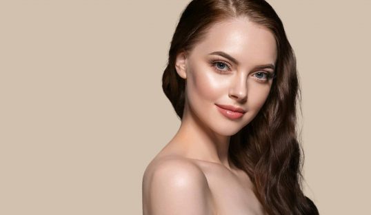 Beautiful hair skin woman beauty female portrait natural make up long hair. Color background brown