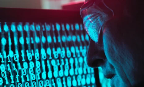 man looking at numbers on screen